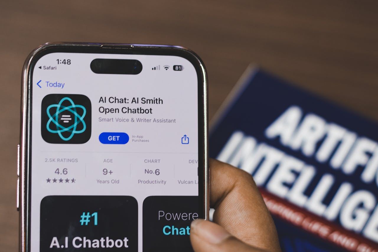 creative Hand holding a smartphone with AI chatbot app, emphasizing artificial intelligence and technology.