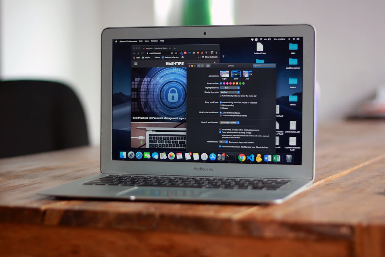creative-03 Open MacBook Air with apps and web browser on screen, placed on a wooden table indoors.